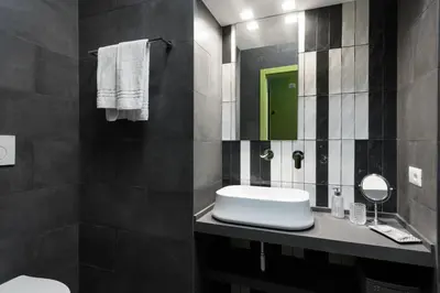 a black and white bathroom with a sink and a mirror at Circle in the Square in Rome