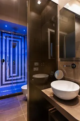 a bathroom with two sinks and a glass shower at Circle in the Square in Rome