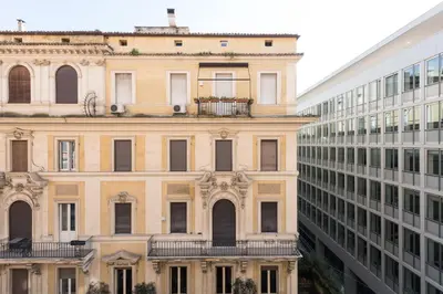 an old building next to a tall building at Circle in the Square in Rome