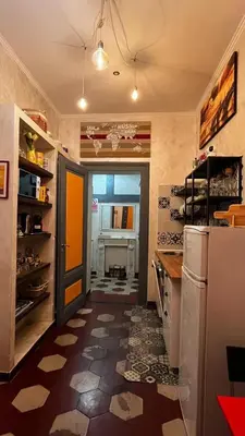 a kitchen with a refrigerator and a door in a room at Da Vinci in Rome