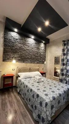 a bedroom with a bed and a brick wall at Da Vinci in Rome