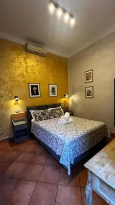 a bedroom with a bed and a table in a room at Da Vinci in Rome