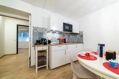 a kitchen with a table and a dining room at Domus Domi Barberini Sq. in Rome