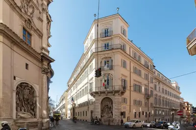 a tall building with a clock tower on a street at Domus Domi Barberini Sq. in Rome