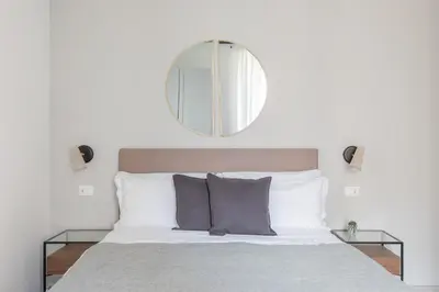 a bedroom with a bed with a mirror above it at Saint Peter Elegant and Charming Apartment in Rome