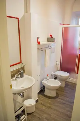 a bathroom with two sinks and a toilet and a shower at Relais Cola Di Rienzo in Rome