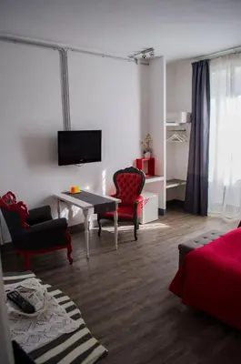 a living room with a table and chairs and a television at Relais Cola Di Rienzo in Rome