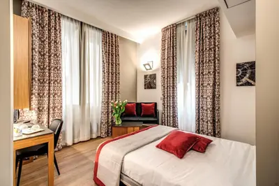 a hotel room with a bed and a desk and a chair at Maison Ripetta in Rome