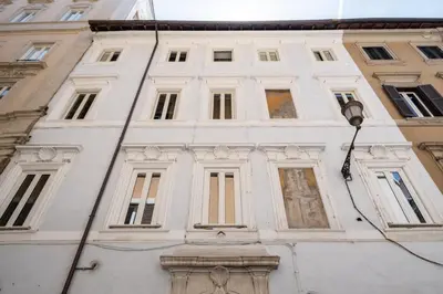 a white building with many windows and a street light at 19 Steps Trevi in Rome