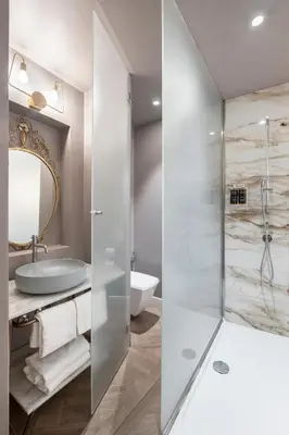 a bedroom with a large white bed and a sink at 19 Steps Trevi in Rome