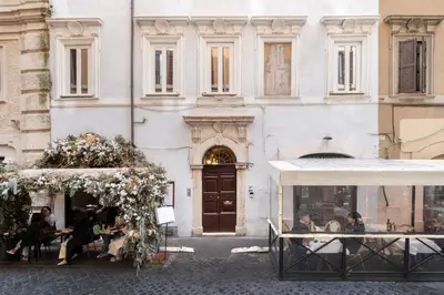 a bedroom with a large white bed and a mirror at 19 Steps Trevi in Rome