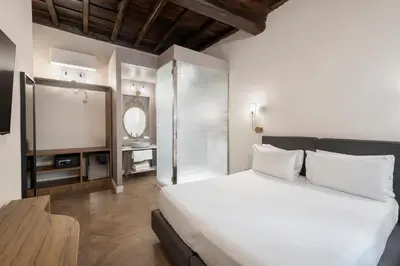 a bedroom with a white bed and a window at 19 Steps Trevi in Rome