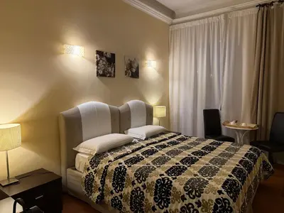a bedroom with a bed with a black and white comforter at Glamour Center Of Rome in Rome