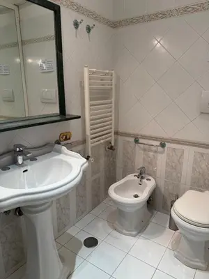 a bathroom with a sink and a toilet and a mirror at Glamour Center Of Rome in Rome