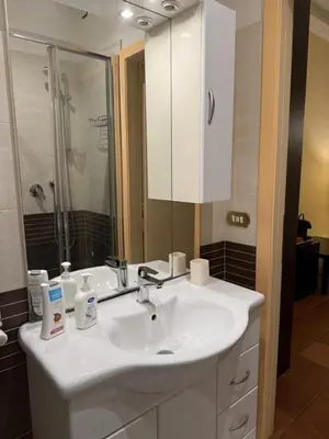 a bathroom with a white sink and a mirror at Glamour Center Of Rome in Rome