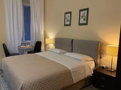 a bedroom with a large bed with two pillows at Glamour Center Of Rome in Rome