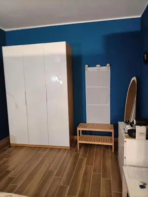 a room with a white closet and a wooden floor at Colombo Holidays APT in Rome