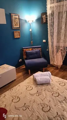 a living room with a couch and a blue wall at Colombo Holidays APT in Rome