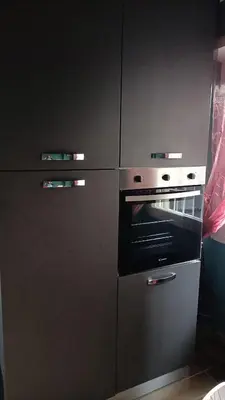 a gray kitchen with an oven and cabinets at Colombo Holidays APT in Rome