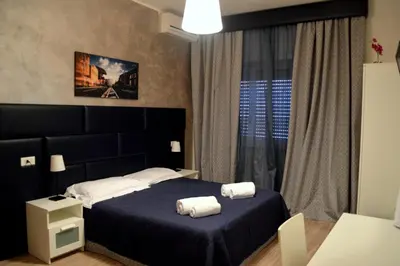 a bedroom with a bed with two towels on it at Check-Inn Rooms in Rome
