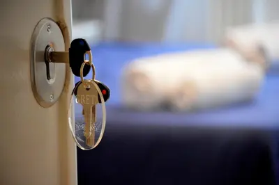 a key in a lock on a door at Check-Inn Rooms in Rome