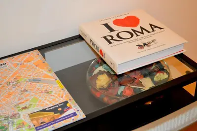 a book sitting on top of a table with a bowl of candy at Check-Inn Rooms in Rome