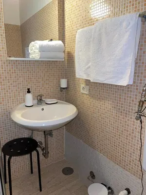 a bathroom with a white sink and a towel at Guest House Meret in Rome