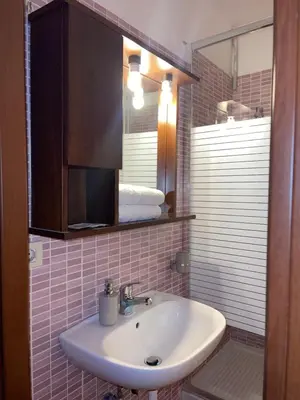a bathroom with a sink and a mirror at Guest House Meret in Rome