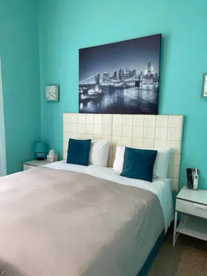 a bedroom with a large bed with a blue wall at Guest House Meret in Rome