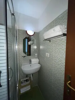 a small bathroom with a sink and a shower at Guest House Meret in Rome