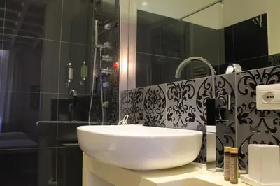 a bathroom with a white sink and a shower at Di Rienzo Pantheon Palace in Rome