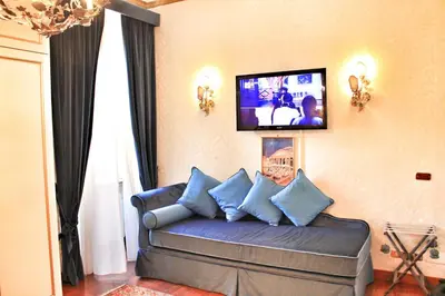 a living room with a couch with a tv on the wall at Di Rienzo Pantheon Palace in Rome