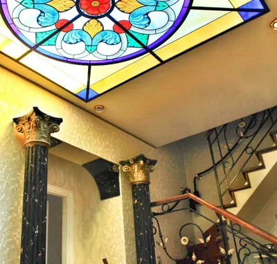 a stained glass window on the ceiling of a staircase at Di Rienzo Pantheon Palace in Rome