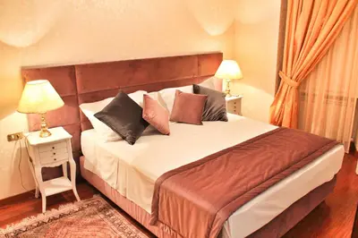 a bedroom with a large bed with pillows on it at Di Rienzo Pantheon Palace in Rome