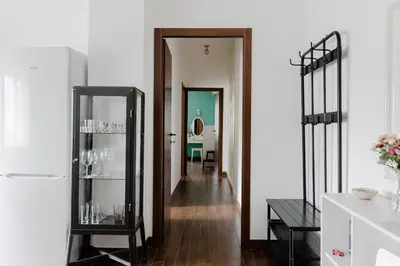a hallway with a glass cabinet in a room at Scarfoglio Apartment, 4 persone, 2 camere, balcone, Wi-Fi, Stazione Tiburtina in Rome