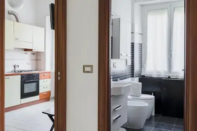 a white bathroom with a toilet and a sink at Casa Flo in Rome