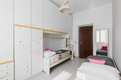 a bedroom with two twin beds and a closet at Casa Flo in Rome