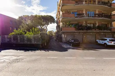 a car parked in front of a building at Charming Apartment with Garden, Parking & Metro in Rome