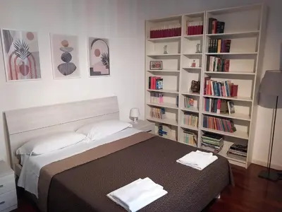 a bedroom with a bed with two towels on it at La Favola di San Pietro in Rome