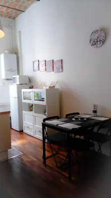 a kitchen with a table and a refrigerator at La Favola di San Pietro in Rome
