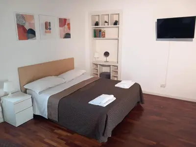 a bedroom with a bed and a television in it at La Favola di San Pietro in Rome