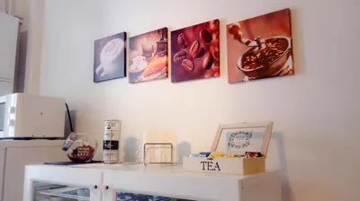 a white table with four pictures on a wall at La Favola di San Pietro in Rome