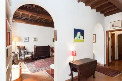 an archway in a living room with a table at Libri Flat in Rome