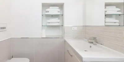 a bathroom with a sink and a toilet and towels at Libri Flat in Rome