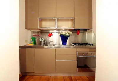 a kitchen with a sink and a stove at Lovely Maisonette Trastevere in Rome