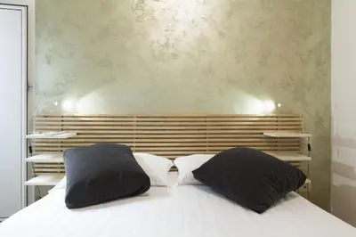 a bedroom with a bed with two pillows on it at Lovely Maisonette Trastevere in Rome