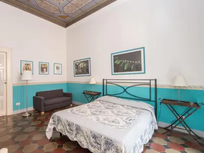 a bedroom with a bed and a chair at Apartment Romantico by Interhome in Rome
