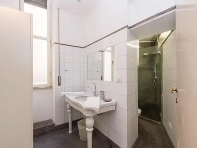 a white bathroom with a sink and a shower at Apartment Romantico by Interhome in Rome