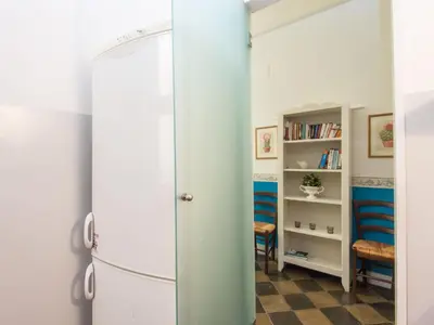 a vintage refrigerator in a room with a book shelf at Apartment Romantico by Interhome in Rome