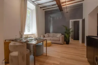 a living room with a table and a couch at Charme apartment with Spa in Piazza del Popolo in Rome